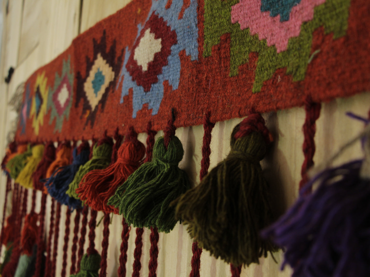 Close-up of handcrafted Gelim window topper showcasing Persian weaving technique, perfect for adding cultural character to windows