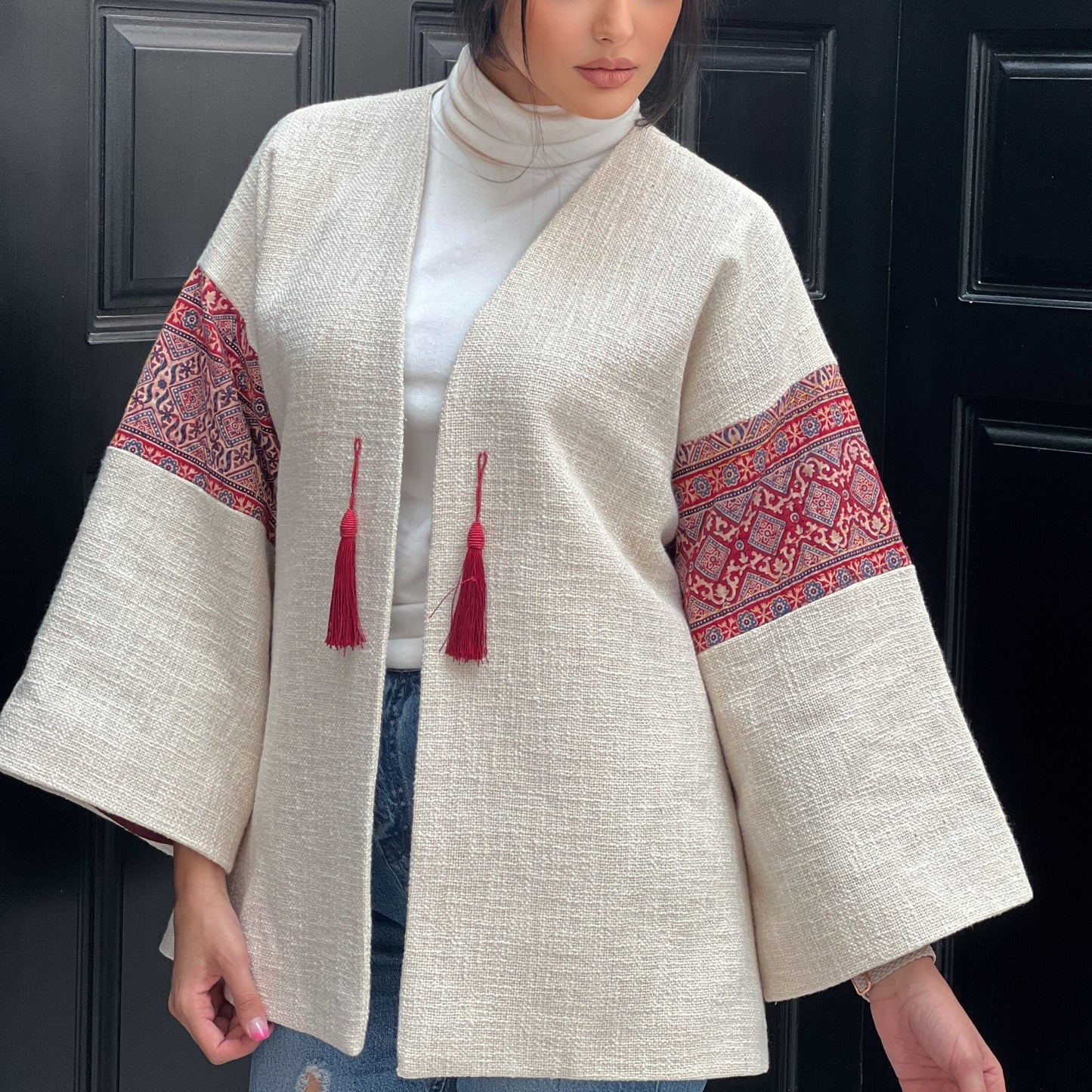 Front view of Fusion Jacket with intricate hand embroidery and red tassels, perfect for holiday events and office wear