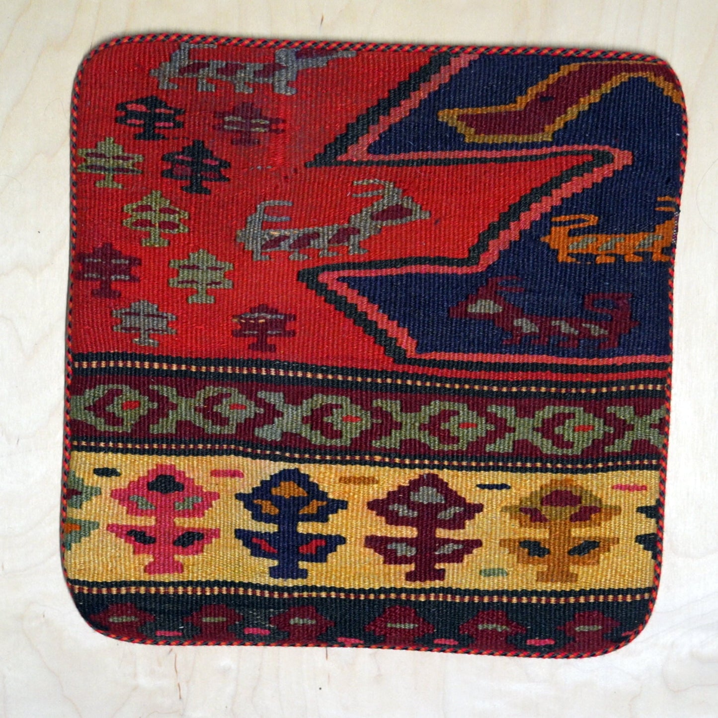 Handcrafted Persian Gelim cushion featuring traditional weaving and bright colors, perfect for adding cultural elegance to any space