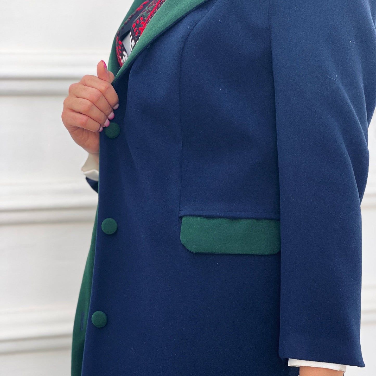 Long Nexus Coat in navy blue with a contrasting green lapel, designed for modern style and versatility.