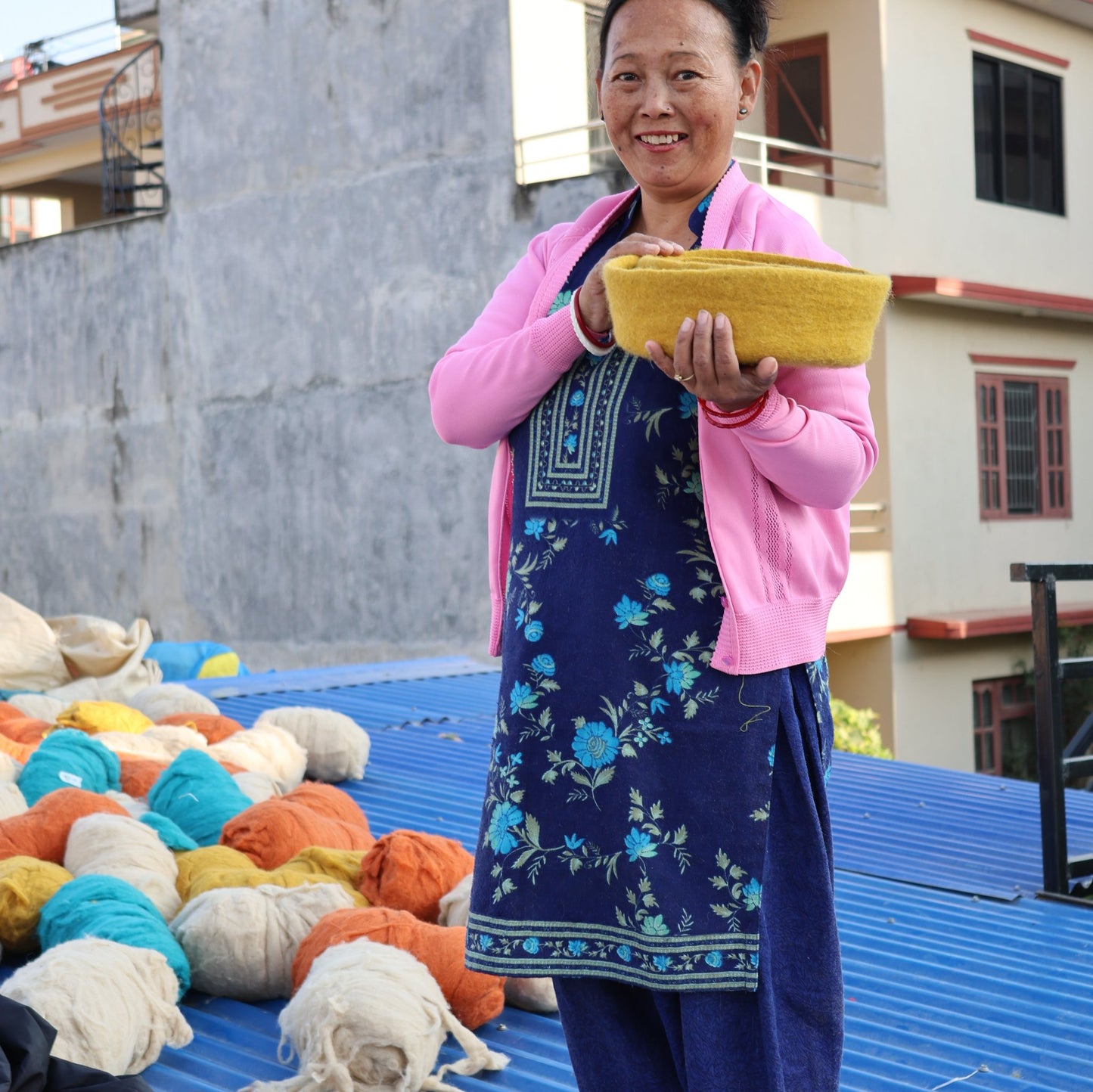 a Nepali artisan supported by Gry & Sif’s fair trade practices, specializing in handcrafted wool decor