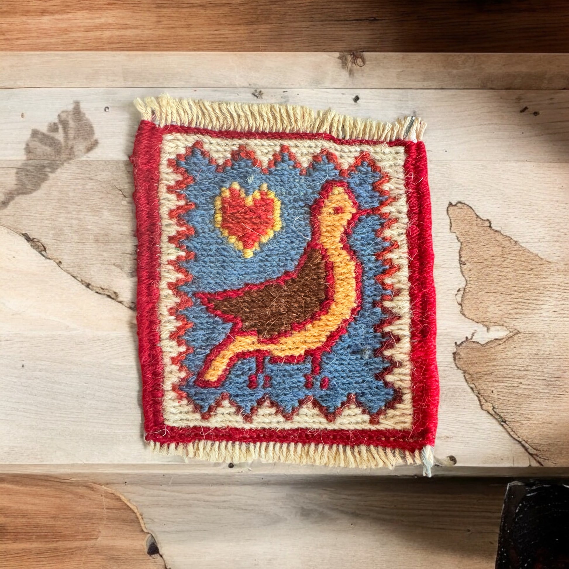 Artisan-made Persian Gelim coasters with colorful, playful patterns, offering both style and surface protection