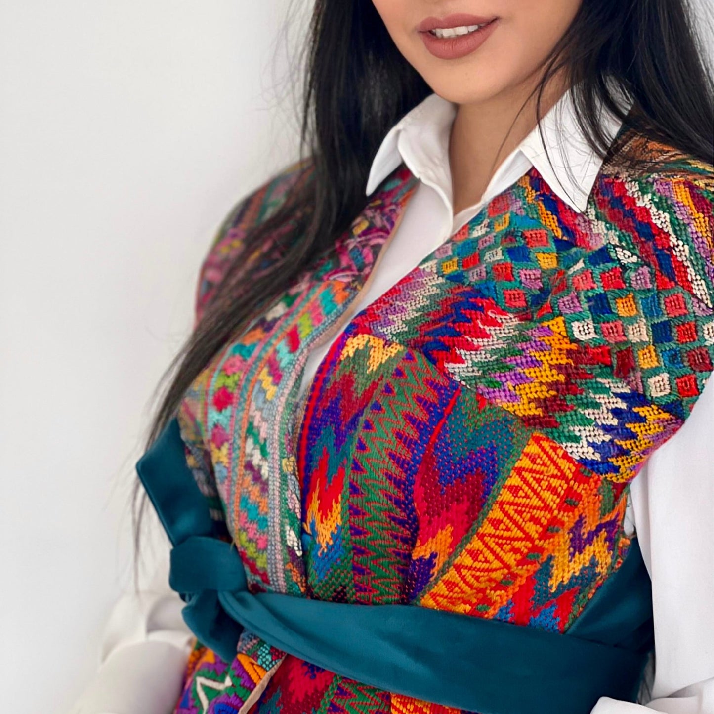 Bold Radiance Vest with colorful hand embroidery, adjustable teal tie belt, and velvet back fabric for a unique look