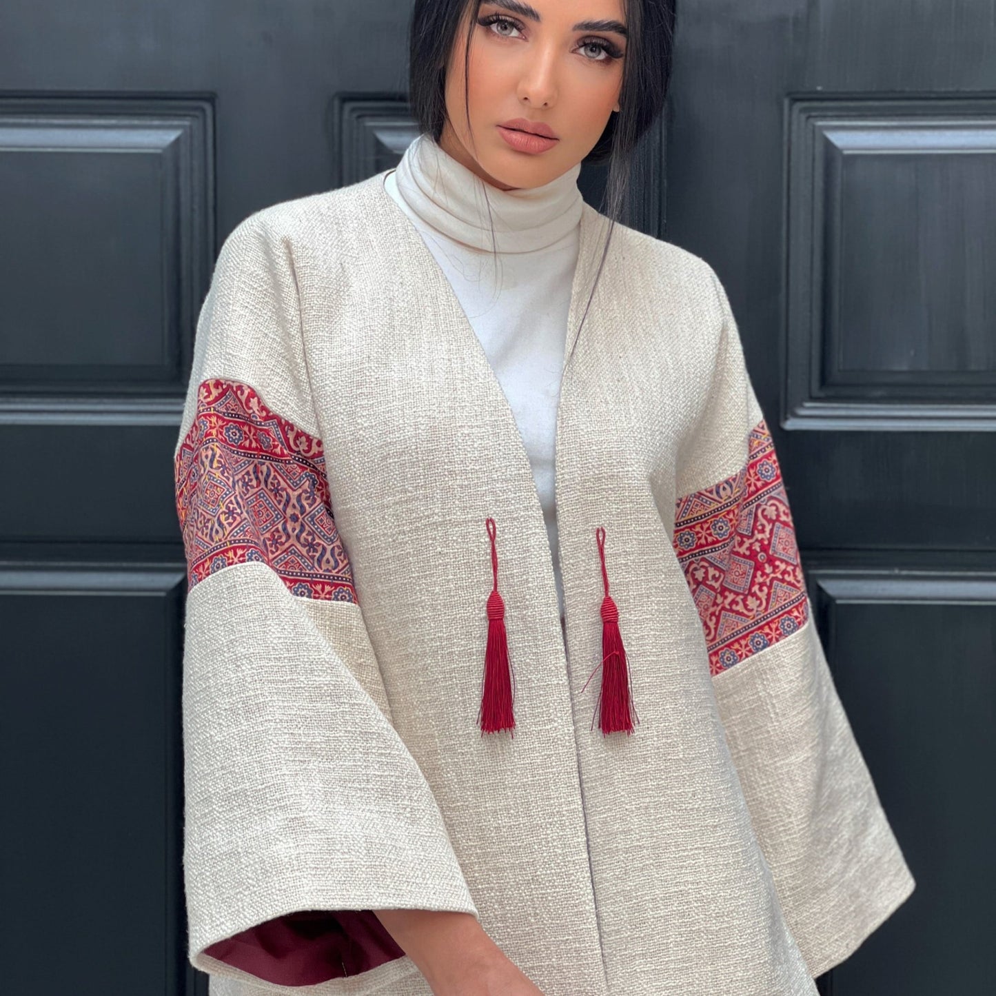 Fusion Jacket showcasing red tassel ties and hand-embroidered details on a soft felt base, perfect for both office and evening wear