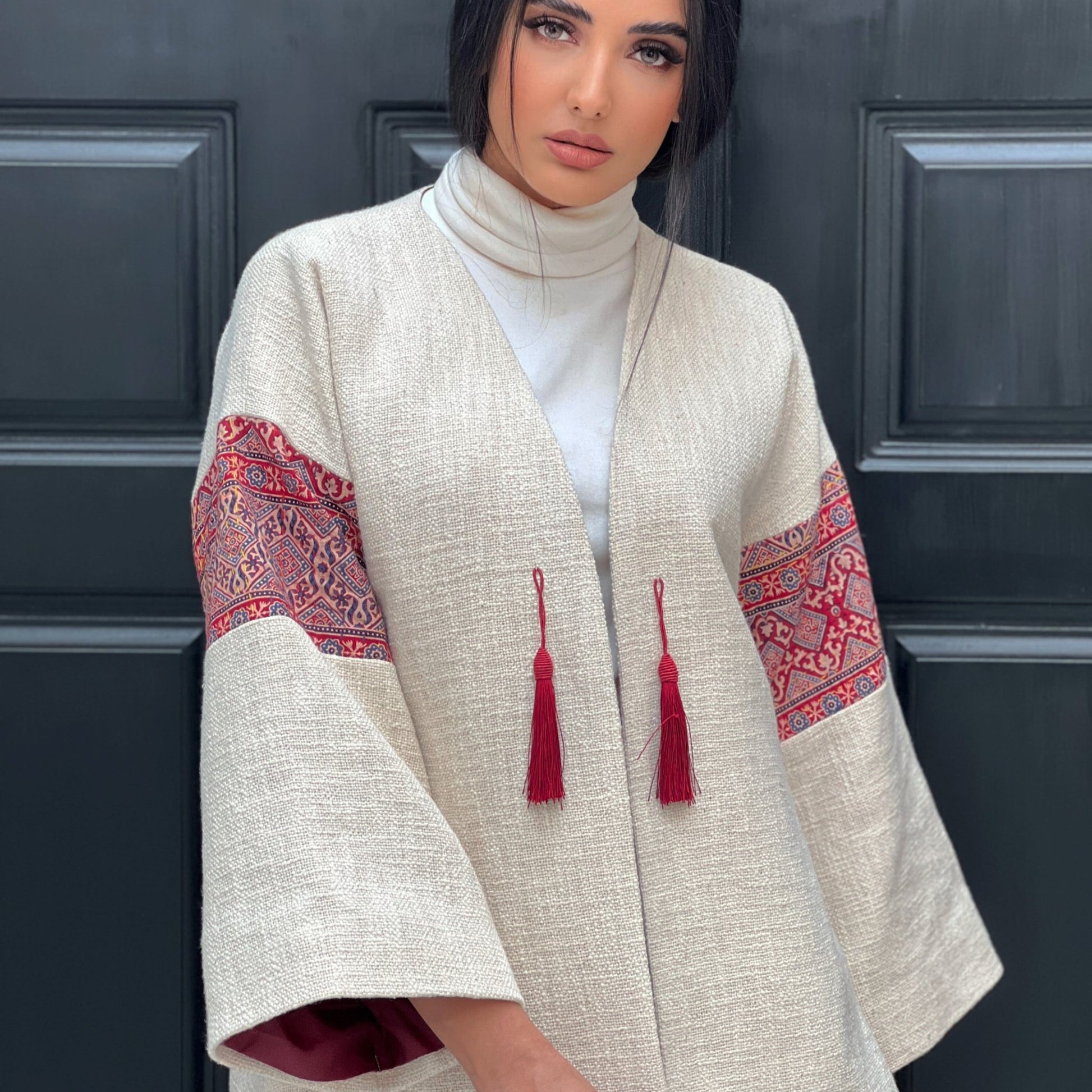 Fusion Jacket showcasing red tassel ties and hand-embroidered details on a soft felt base, perfect for both office and evening wear