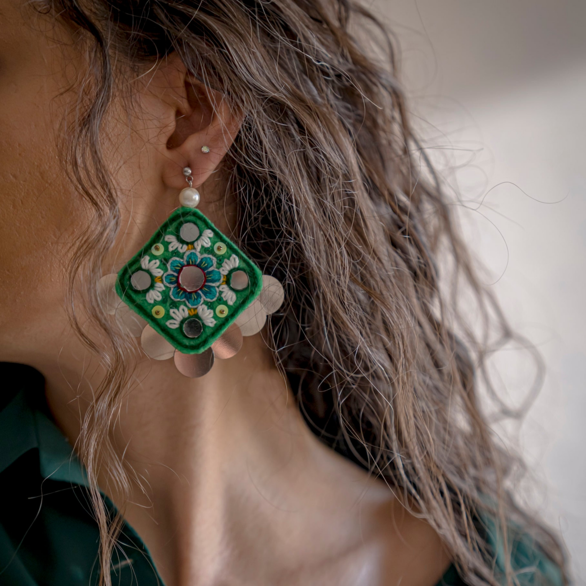 Close-up of handcrafted Blossom Earrings featuring Persian-inspired floral design, symbolizing growth and resilience, made with sustainable practices