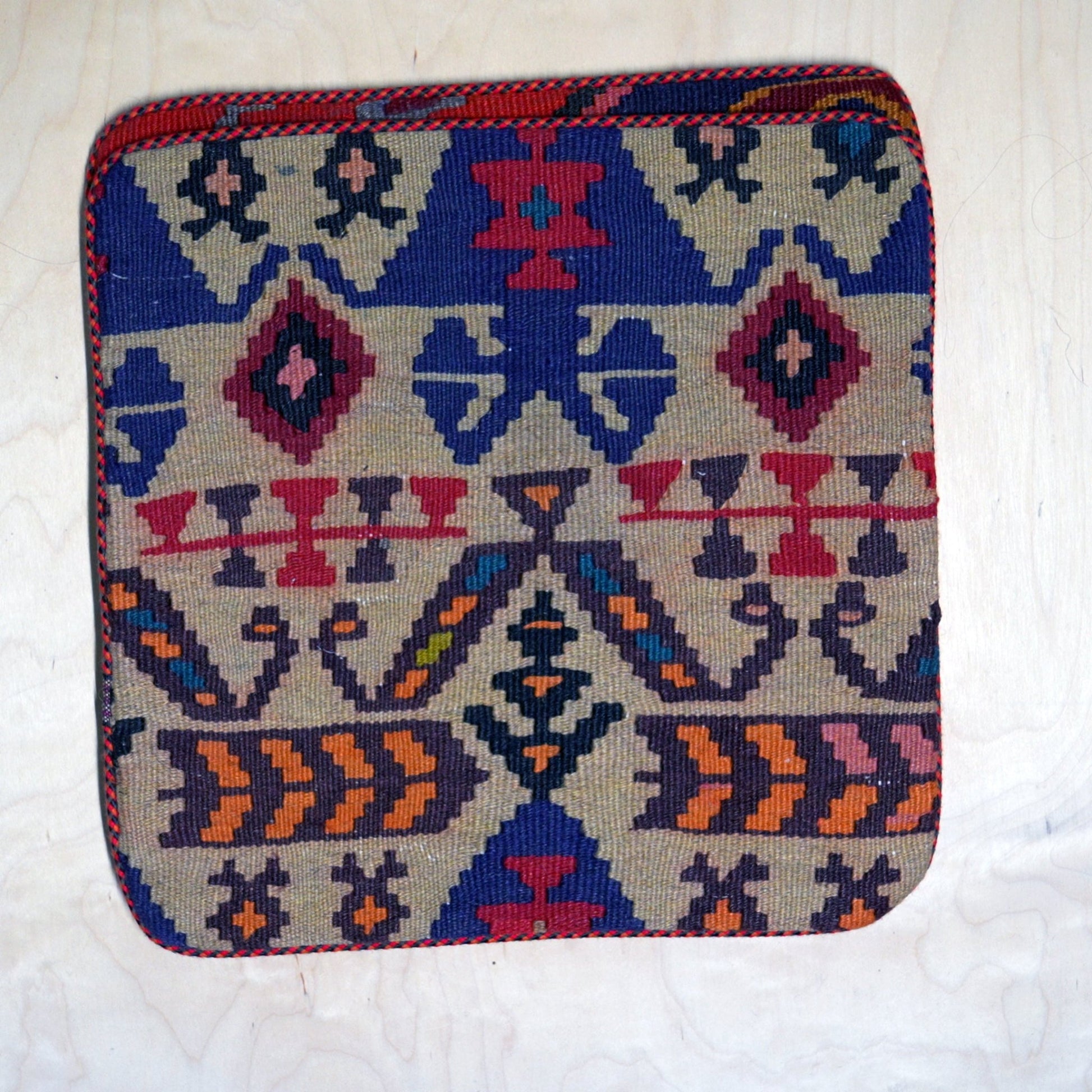 Unique Persian Gelim cushion cover, featuring traditional weaving techniques and vibrant colors, perfect for holiday deco
