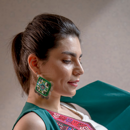 Close-up of handcrafted  Earrings featuring Persian-inspired floral design, symbolizing growth and resilience, made with sustainable practices