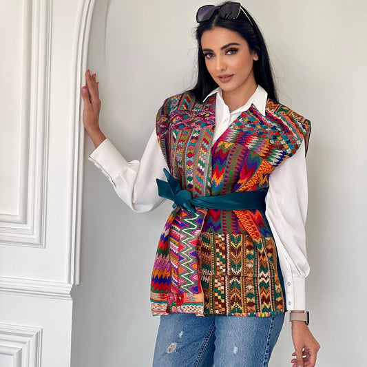 Unique Radiance Vest featuring multi-patterned hand-embroidered front and teal tie belt, perfect for versatile styling