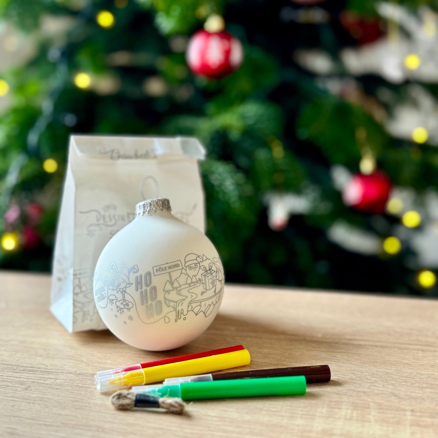 Eco-friendly DIY Christmas craft kit for children, featuring a glass bauble and coloring markers.